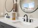 Dual vanity bathroom with quartz countertop and matte black hardware fixtures at 9930 W 82Nd Ave, Arvada, CO 80005