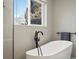 Close up of bathroom with modern tub and matte black hardware fixtures at 9930 W 82Nd Ave, Arvada, CO 80005