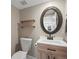 Charming half bathroom with a vanity, decorative mirror, and stylish fixtures, adding a touch of elegance at 9930 W 82Nd Ave, Arvada, CO 80005