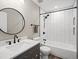Full bathroom with tub and shower combination and gray vanity cabinet at 9930 W 82Nd Ave, Arvada, CO 80005