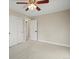 Bedroom with carpeted floors, ceiling fan, two closets and neutral walls at 9930 W 82Nd Ave, Arvada, CO 80005
