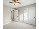 Bright carpeted bedroom featuring large closets, neutral walls, ceiling fan and doors leading out of the room at 9930 W 82Nd Ave, Arvada, CO 80005