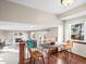 Upstairs dining area next to living room features wood floors, bright window, and modern decor at 9930 W 82Nd Ave, Arvada, CO 80005