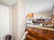 Warm entryway with hardwood stairs, wood floors, and a view into the living room and dining area at 9930 W 82Nd Ave, Arvada, CO 80005