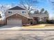 Charming two-story home featuring brick accents, a well-manicured lawn, and an attached two-car garage at 9930 W 82Nd Ave, Arvada, CO 80005