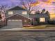 Charming two-story home featuring brick and gray siding, a two-car garage, and a well-maintained front yard at 9930 W 82Nd Ave, Arvada, CO 80005