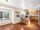 Expansive kitchen with a breakfast nook featuring wood cabinets, granite countertops, and hardwood floors at 9930 W 82Nd Ave, Arvada, CO 80005