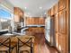 Spacious kitchen with wood cabinets, granite countertops, stainless steel appliances, and hardwood floors at 9930 W 82Nd Ave, Arvada, CO 80005