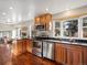 Bright kitchen with stainless steel appliances, wood cabinets, granite countertops, and an open layout at 9930 W 82Nd Ave, Arvada, CO 80005