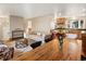 Open-concept living room with hardwood floors, a dining table, a comfortable sofa, and stylish decor at 9930 W 82Nd Ave, Arvada, CO 80005