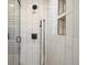 Close up of walk-in shower with shower head, hand shower, and shower caddy at 9930 W 82Nd Ave, Arvada, CO 80005