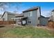 A beautiful backyard featuring a hot tub, grassy lawn, and shed for outdoor activities at 10405 Dresden St, Firestone, CO 80504