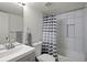 Modern bathroom boasts tiled shower, modern fixtures, vanity with sink, and a toilet at 10405 Dresden St, Firestone, CO 80504