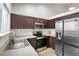 Functional kitchen with stainless steel appliances, dark wood cabinetry, and plenty of counter space at 10405 Dresden St, Firestone, CO 80504