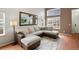 Spacious living room showcasing a large sectional sofa, modern decor, and ample natural light at 10405 Dresden St, Firestone, CO 80504