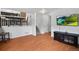 Spacious living room features laminate flooring, stairs to the second level, and a television mounted on the wall at 10405 Dresden St, Firestone, CO 80504
