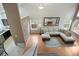 Well-lit living room offering a sectional sofa, wood floors, and a view of the kitchen at 10405 Dresden St, Firestone, CO 80504