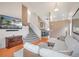 Inviting living room with high ceilings, a modern sectional sofa, and a view of the staircase at 10405 Dresden St, Firestone, CO 80504