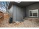 Exterior shed with gray facade, shingle roof, double door, and natural light from the window at 10405 Dresden St, Firestone, CO 80504