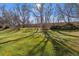 Sprawling backyard with vibrant green grass and mature trees on a bright sunny day at 655 S Alton Way # 6A, Denver, CO 80247