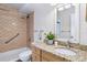 Well-maintained bathroom with granite countertops, updated fixtures, and tiled shower and bath combo at 655 S Alton Way # 6A, Denver, CO 80247