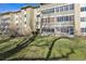 Exterior apartment complex view with spacious lawn and enclosed balcony at 655 S Alton Way # 6A, Denver, CO 80247
