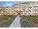 Attractive condo complex exterior featuring a welcoming entrance and well-maintained landscaping at 655 S Alton Way # 6A, Denver, CO 80247