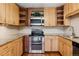 Bright kitchen features wood cabinets, granite countertops, stainless steel appliances, and stylish subway tile backsplash at 655 S Alton Way # 6A, Denver, CO 80247