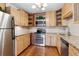 Bright kitchen features wood cabinets, granite countertops, stainless steel appliances, and hardwood flooring at 655 S Alton Way # 6A, Denver, CO 80247
