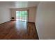 Bright living room with hardwood floors and sliding glass doors to an enclosed patio at 655 S Alton Way # 6A, Denver, CO 80247