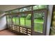 Enclosed patio room with large windows offering serene views of the backyard at 655 S Alton Way # 6A, Denver, CO 80247