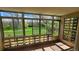 Bright sunroom featuring full view windows and outdoor access to the green lawn and trees at 655 S Alton Way # 6A, Denver, CO 80247