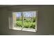 Scenic view from a large window of lush landscaping and mature trees at 655 S Alton Way # 6A, Denver, CO 80247