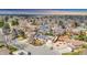 Aerial shot of a neighborhood showcasing the house with solar panels and surroundings at 7727 W 81St Pl, Arvada, CO 80005