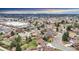 Aerial shot of the property in a suburban setting, with mountain views on the horizon and shopping nearby at 7727 W 81St Pl, Arvada, CO 80005