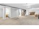 Finished basement featuring a stone fireplace, stairs to the main level, and a bathroom at 7727 W 81St Pl, Arvada, CO 80005