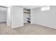 Clean basement room with neutral carpet, closet, and natural light at 7727 W 81St Pl, Arvada, CO 80005