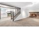 Basement featuring a stone fireplace, stairs leading to a kitchen with stainless steel appliances at 7727 W 81St Pl, Arvada, CO 80005