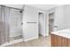 Modern bathroom features a glass-enclosed shower, sleek vanity, and neutral color palette at 7727 W 81St Pl, Arvada, CO 80005
