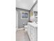 Well-lit bathroom with a white vanity, neutral flooring, and modern fixtures at 7727 W 81St Pl, Arvada, CO 80005