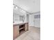 Bathroom features a wood vanity, double sinks, large mirror, and wood plank flooring at 7727 W 81St Pl, Arvada, CO 80005