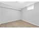 Bedroom with neutral carpet, gray walls, and a small window for natural light at 7727 W 81St Pl, Arvada, CO 80005