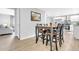 Dining area with modern floors and stylish chairs opens up to the kitchen and living room at 7727 W 81St Pl, Arvada, CO 80005