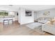 Open-concept living space with modern floors, neutral tones, and a seamless transition to the kitchen area at 7727 W 81St Pl, Arvada, CO 80005