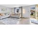 Inviting living room features a cozy sofa, stylish rug, and a bright, airy atmosphere with lots of natural light at 7727 W 81St Pl, Arvada, CO 80005