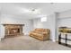 Finished basement living room features a stone fireplace and comfortable seating at 7727 W 81St Pl, Arvada, CO 80005