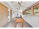 Bright sun room with a foosball table, white walls, multiple windows, and ceiling fans providing natural light at 7727 W 81St Pl, Arvada, CO 80005