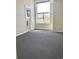 Bright bedroom with a large window offering neighborhood views and neutral carpet, adjacent bathroom at 10150 Belvedere Loop, Lone Tree, CO 80124