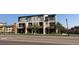 Modern townhome with balconies and contemporary design, set against a blue sky at 10150 Belvedere Loop, Lone Tree, CO 80124