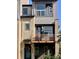 Modern townhome featuring a distinctive facade with mixed materials and a charming Juliet balcony at 10150 Belvedere Loop, Lone Tree, CO 80124